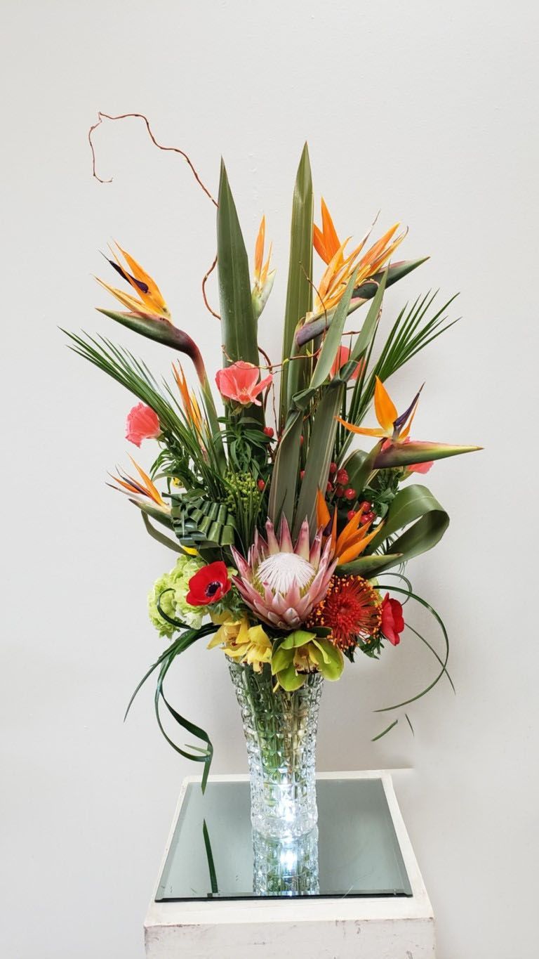 A vase filled with flowers is sitting on a table.