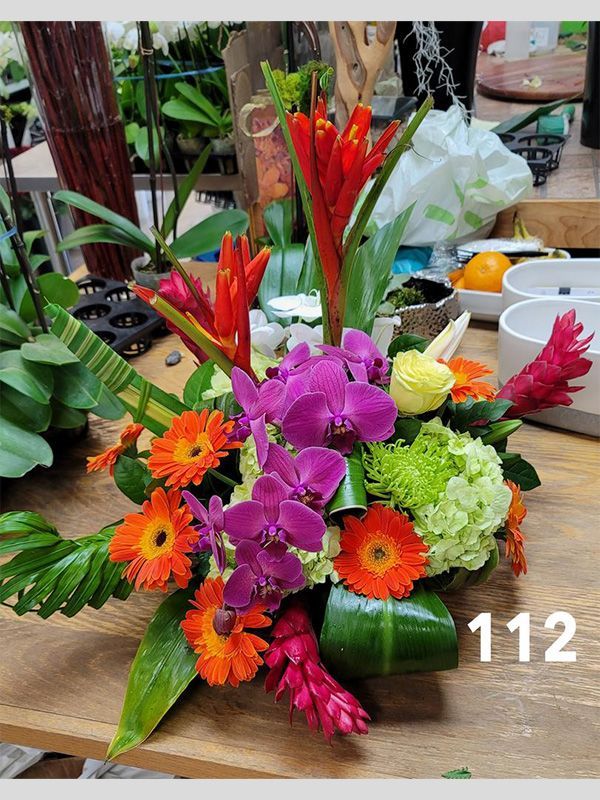 A bunch of flowers are sitting on top of a wooden table.