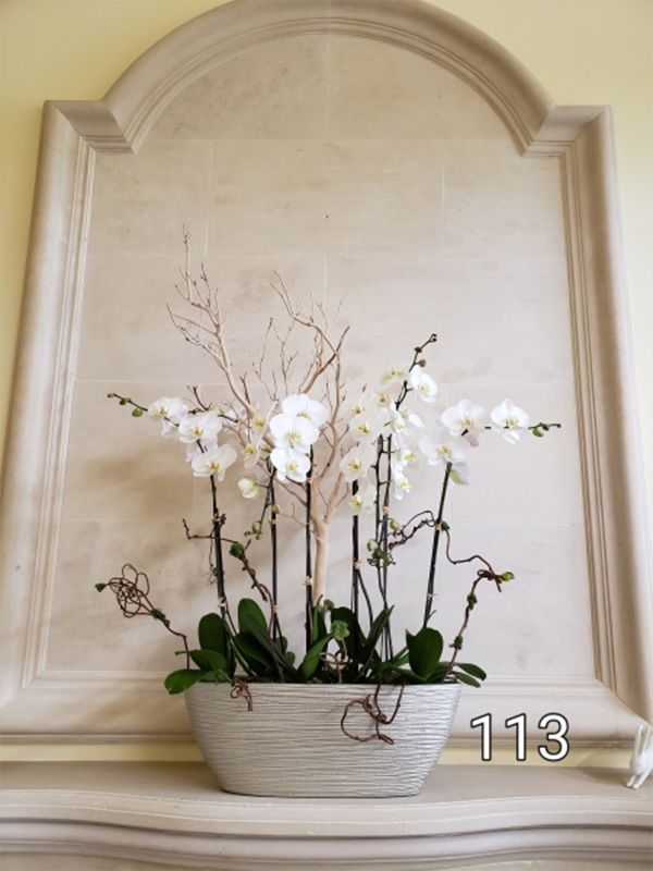 A vase of flowers with the number 113 on it