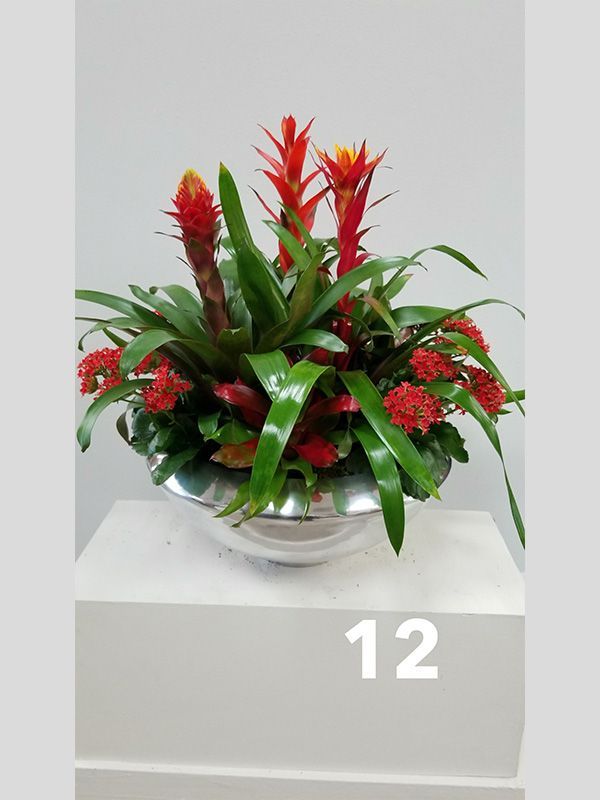 A silver bowl filled with flowers and the number 12