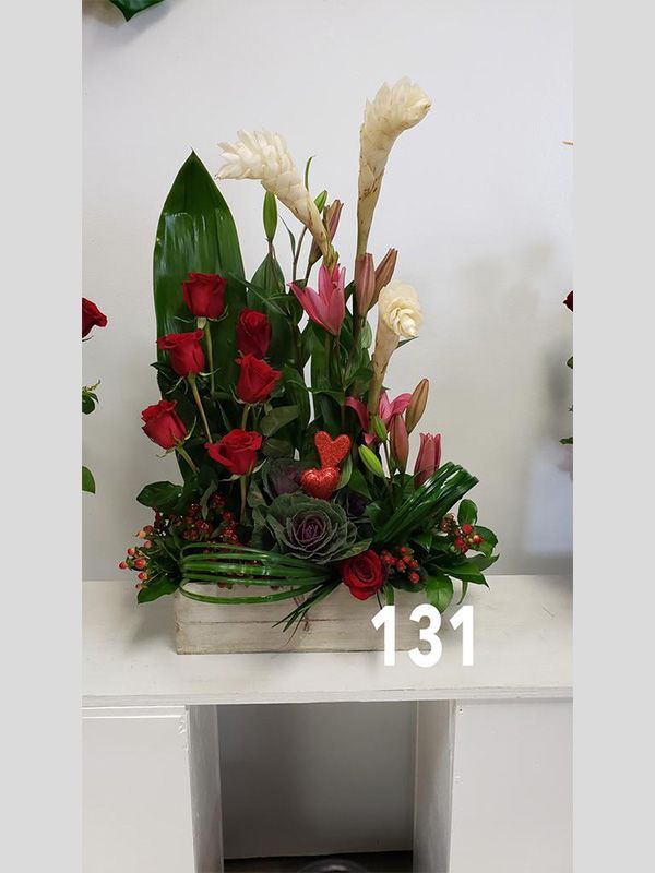 A bouquet of flowers in a wooden box with the number 131 on it.