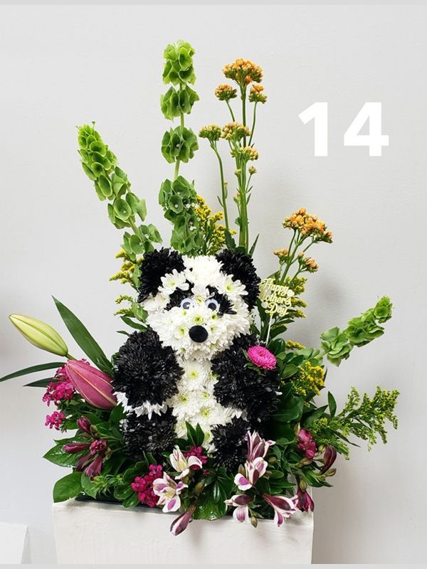 A panda made out of flowers with the number 14 on the bottom
