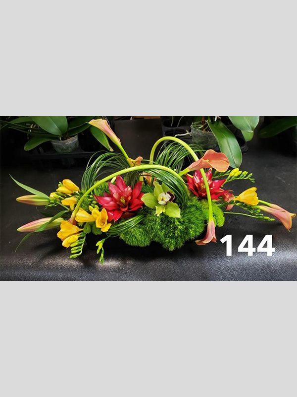 A bunch of flowers are sitting on a table with the number 144 on it.