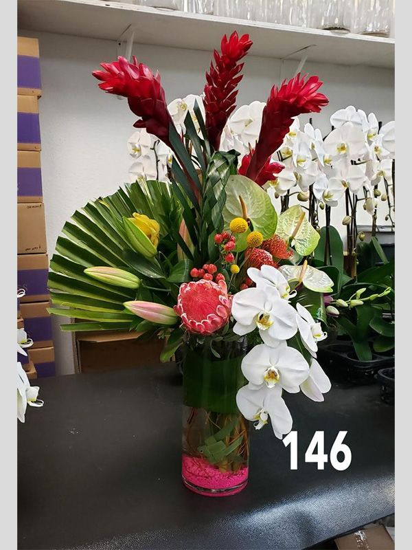 A vase filled with flowers is sitting on a table.