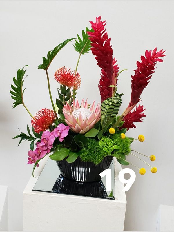 A vase of flowers with the number 19 on it
