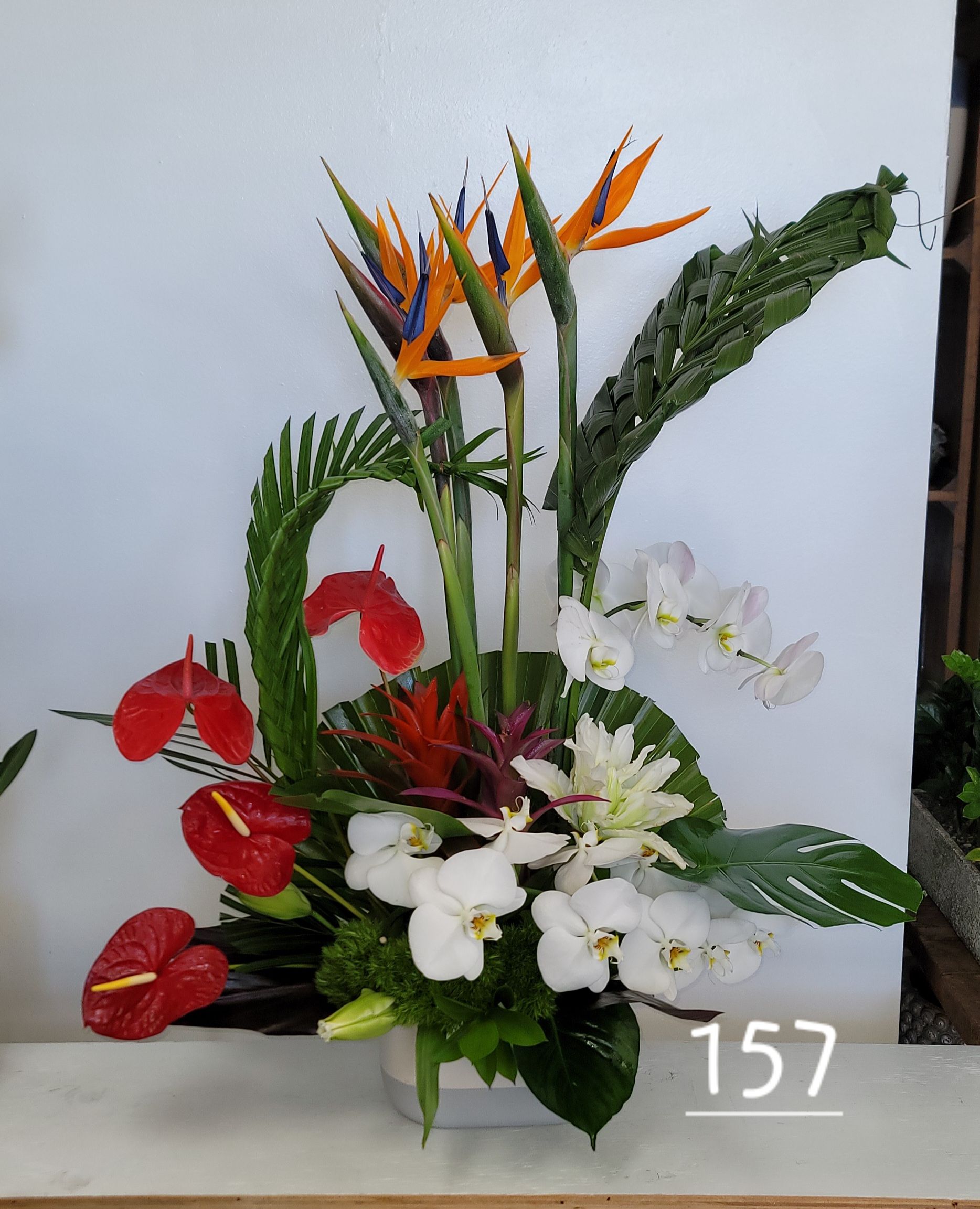A bouquet of flowers with the number 157 next to it