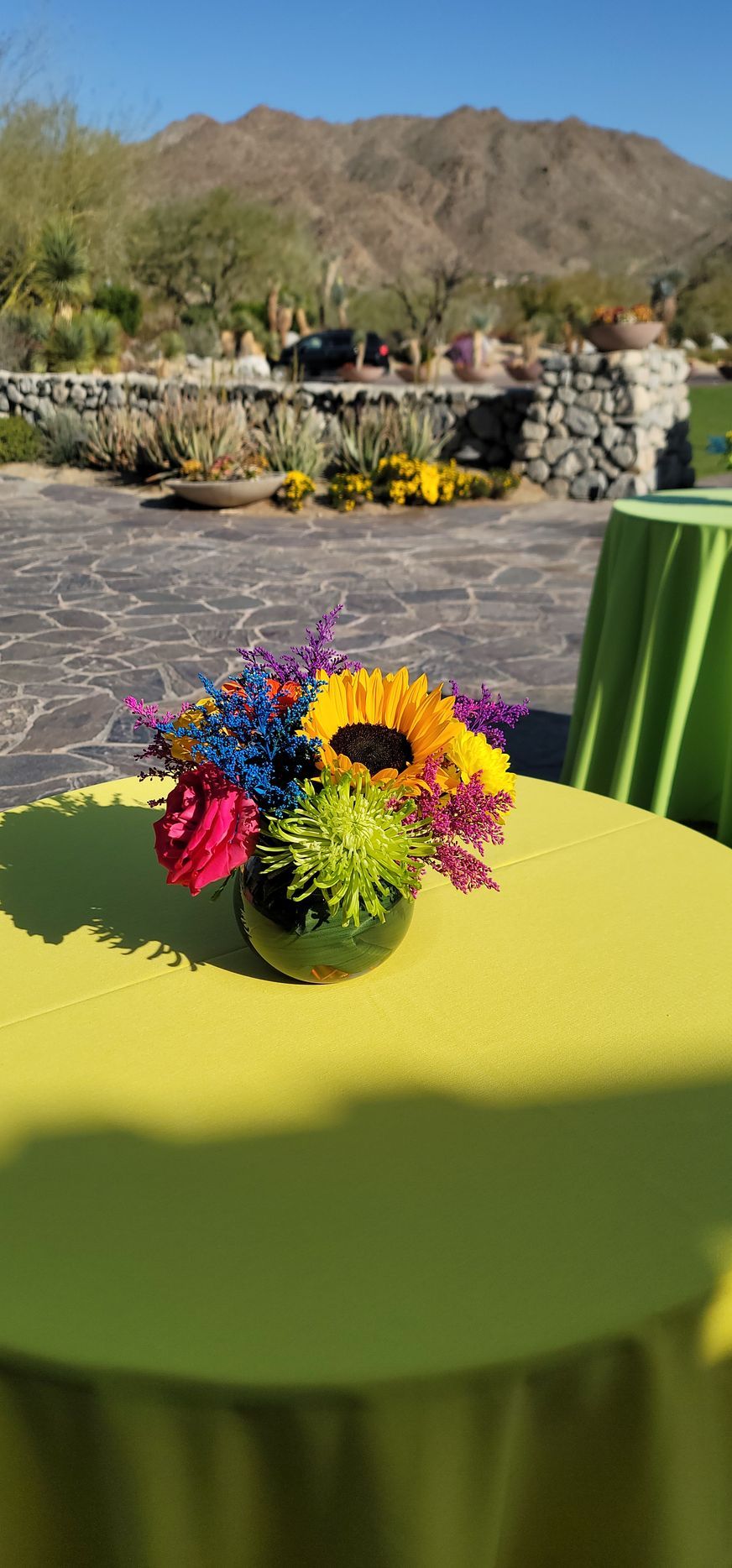 A vase filled with colorful flowers is sitting on a table.