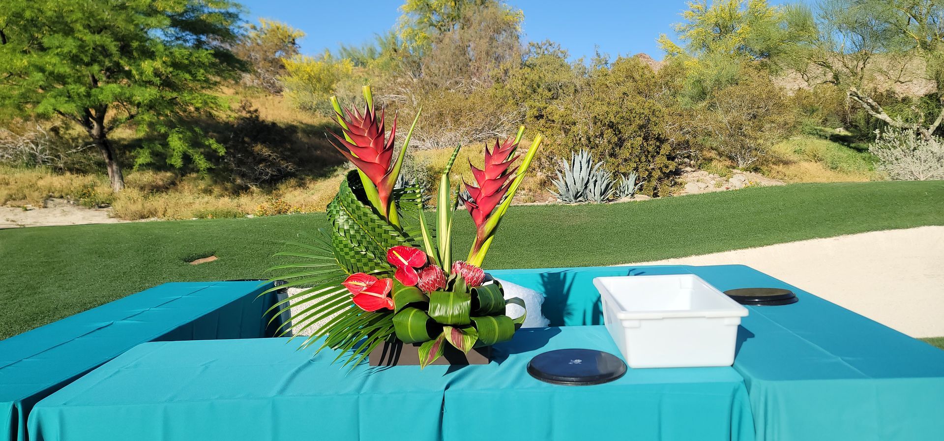 A table with a bouquet of flowers on it.