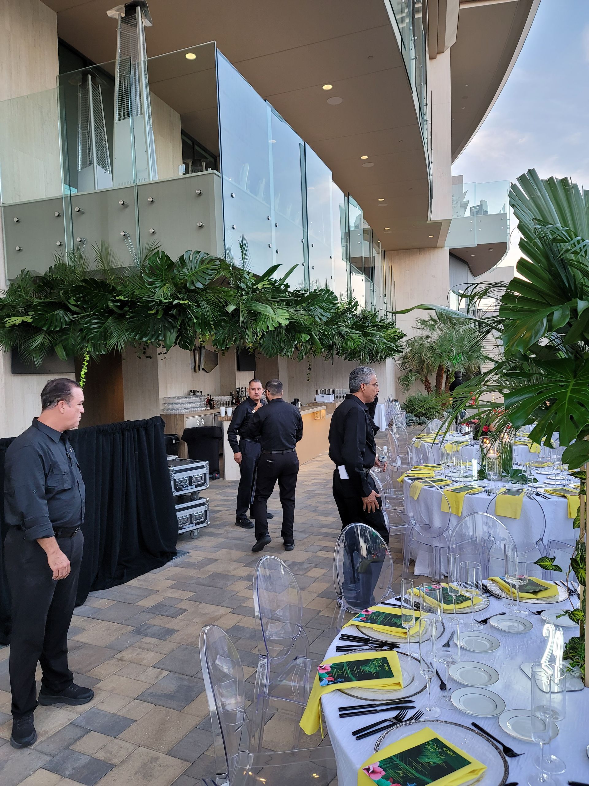 A group of men are standing around a table set for a party.