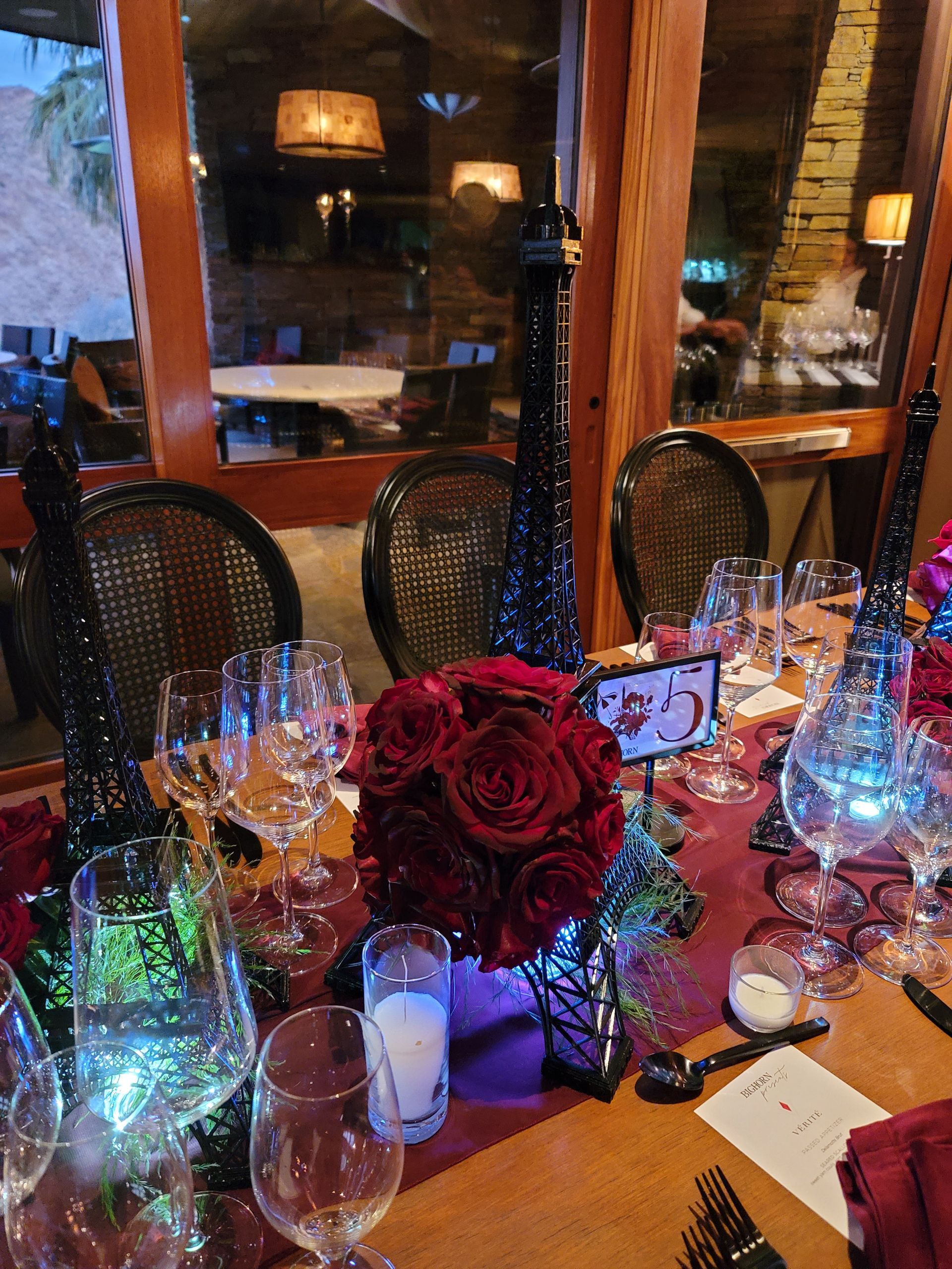 A table with a bunch of glasses and flowers on it