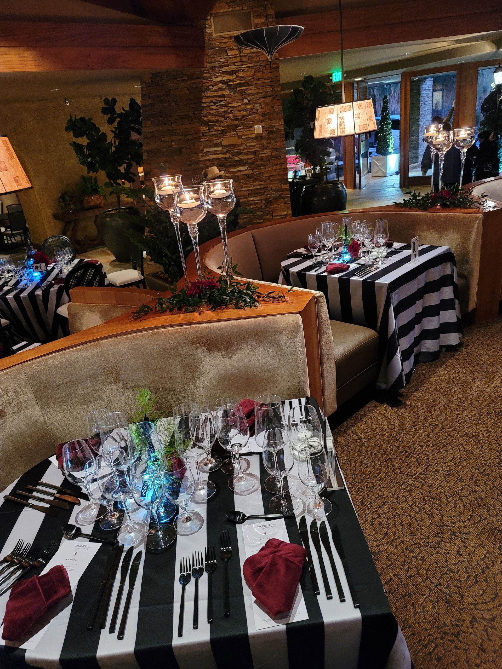 A restaurant with black and white striped tables and chairs
