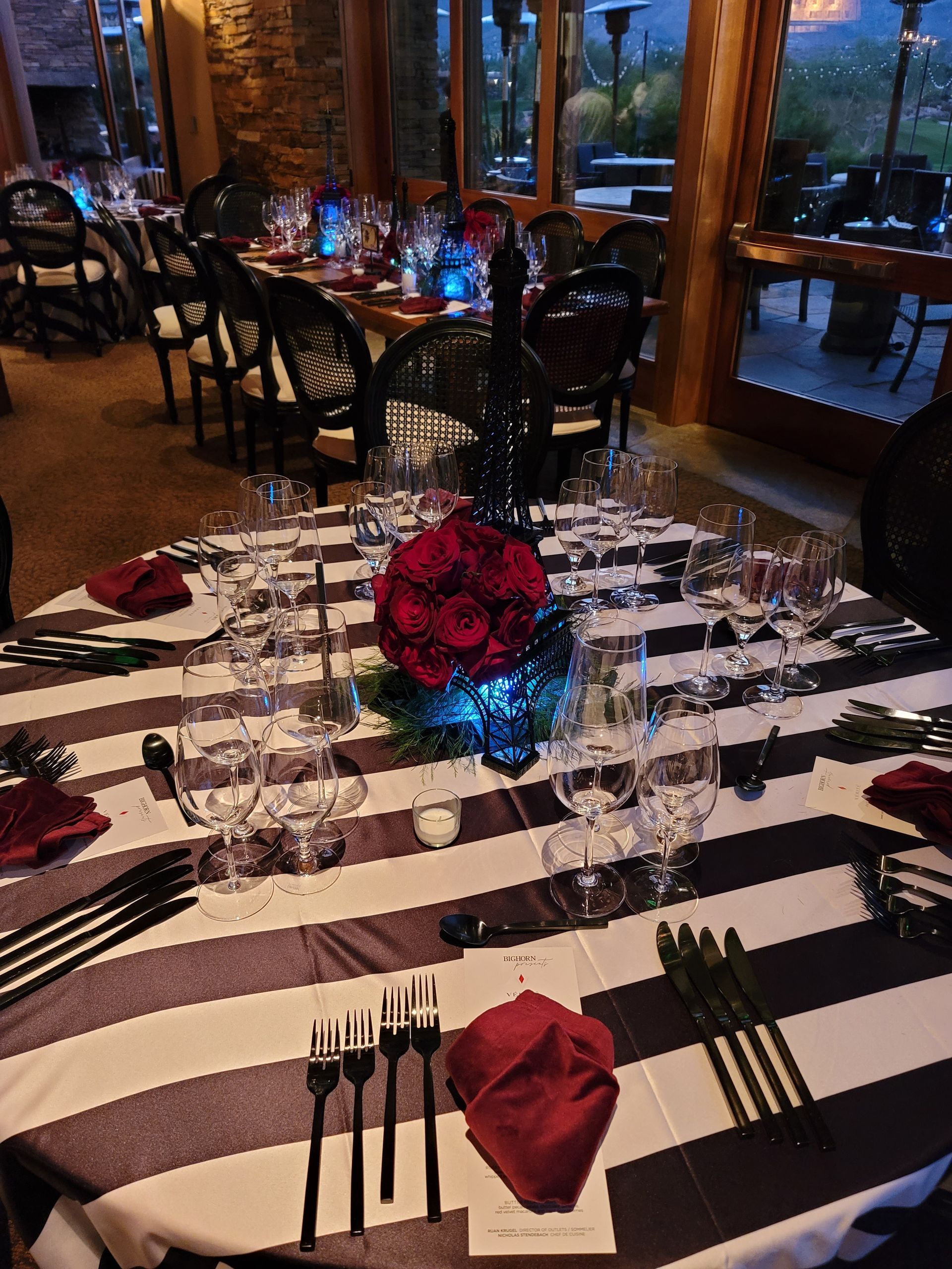 A table set for a dinner party with a striped table cloth