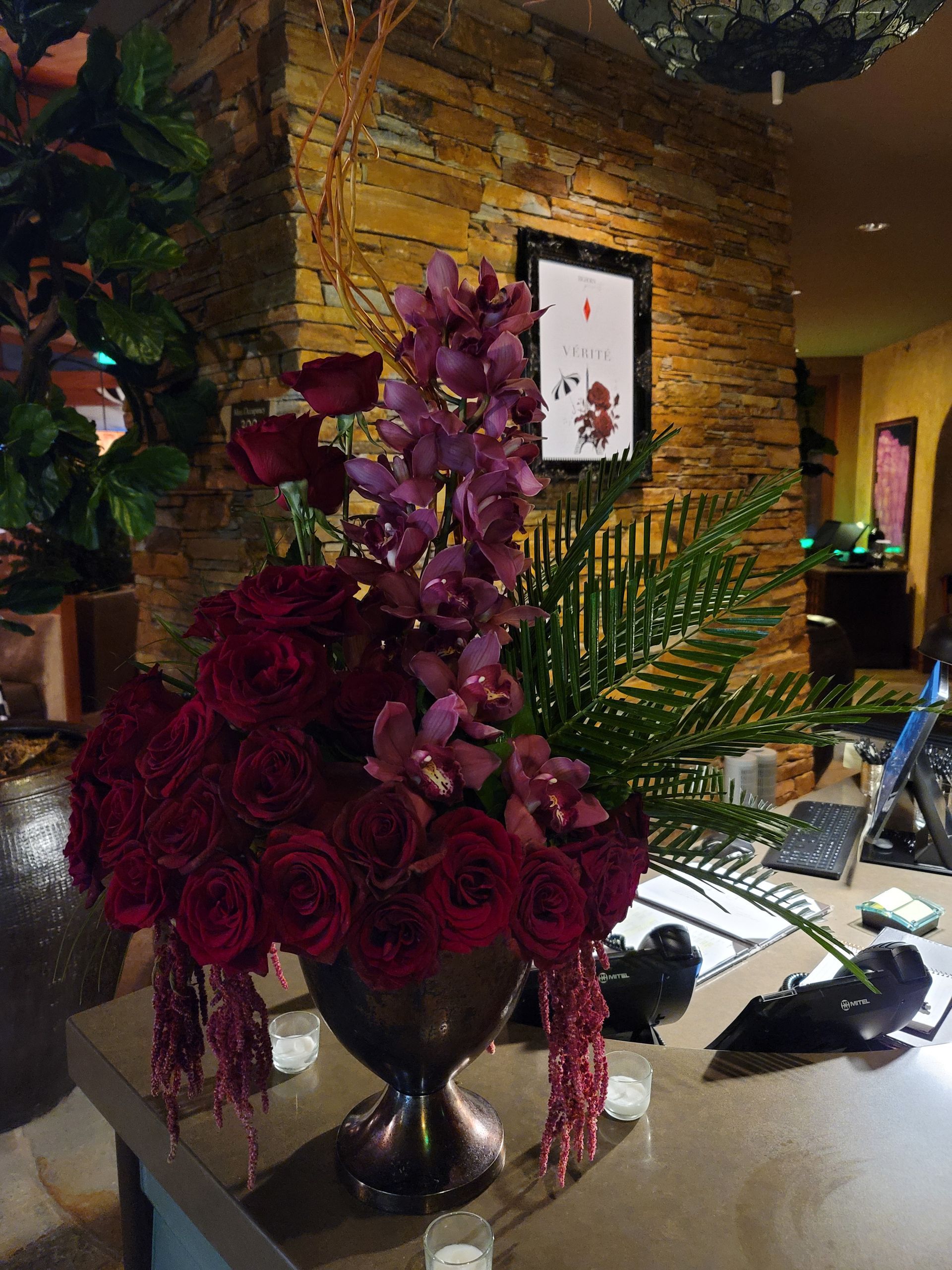 A vase filled with red roses sits on a table