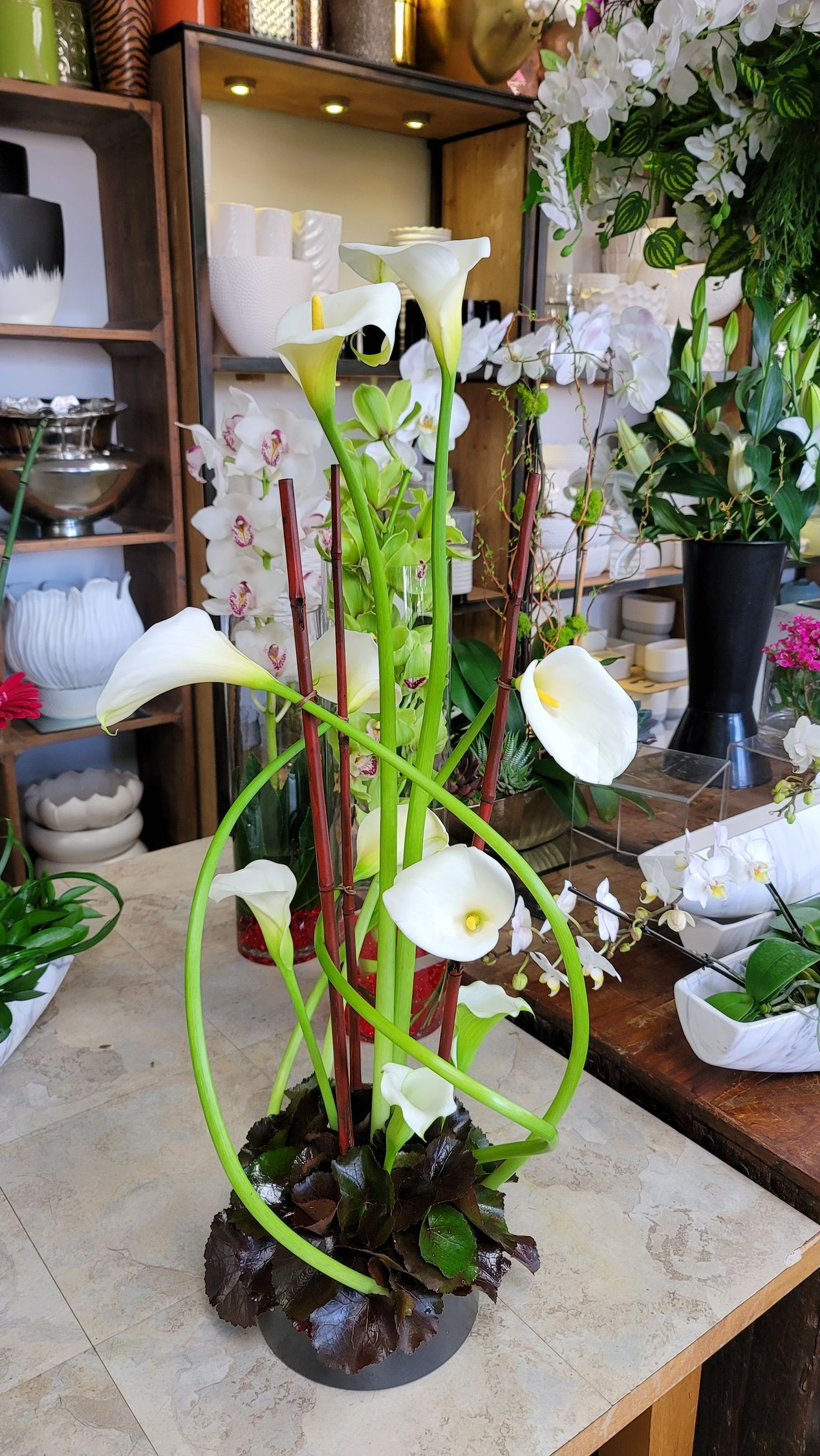 A vase filled with white flowers is sitting on a table.