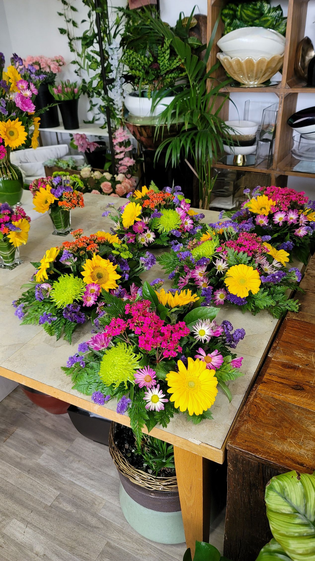 There are many different types of flowers on the table.