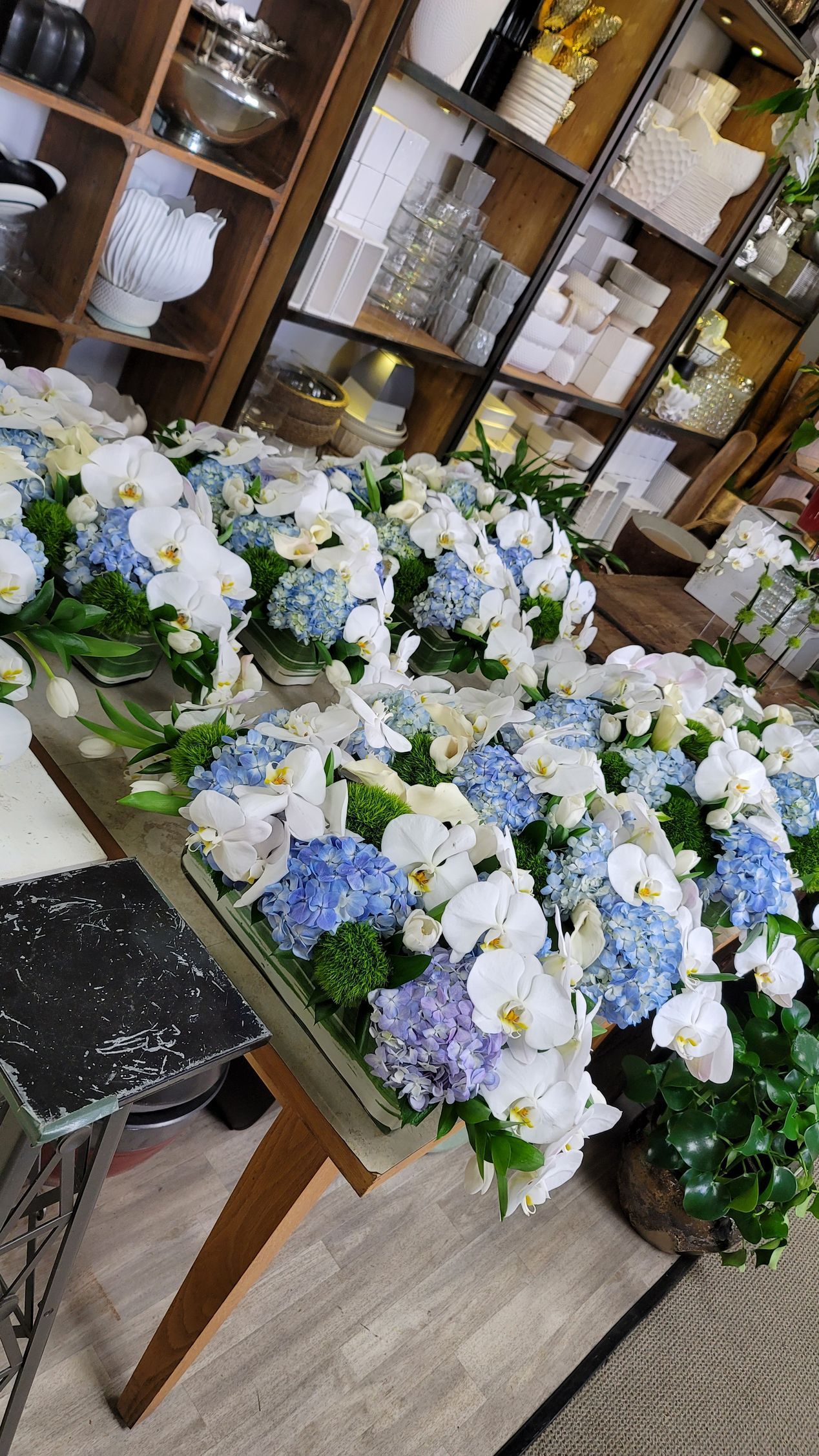 A bunch of flowers are sitting on a table in a room.