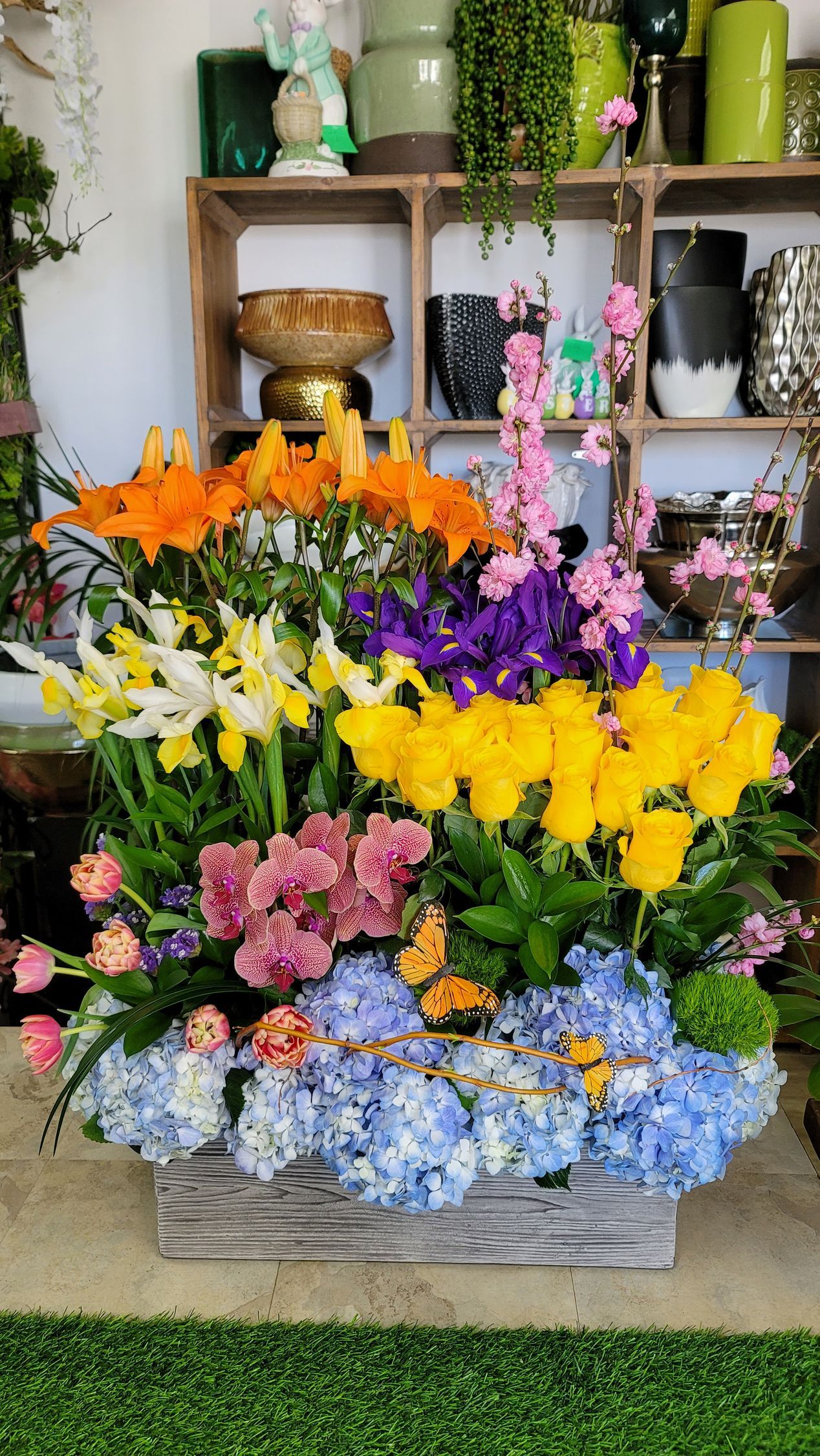 There are many different types of flowers in a wooden box.