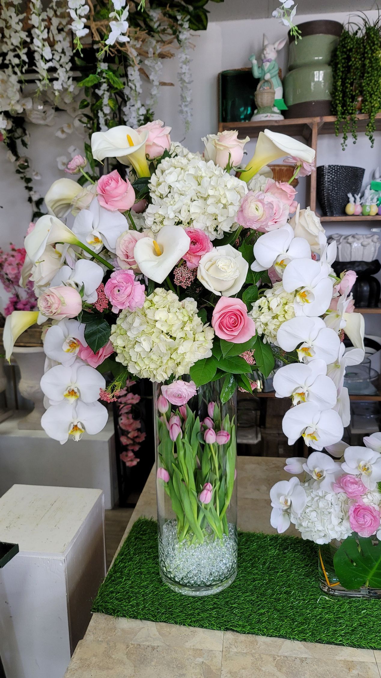 A vase filled with pink and white flowers is sitting on a table.