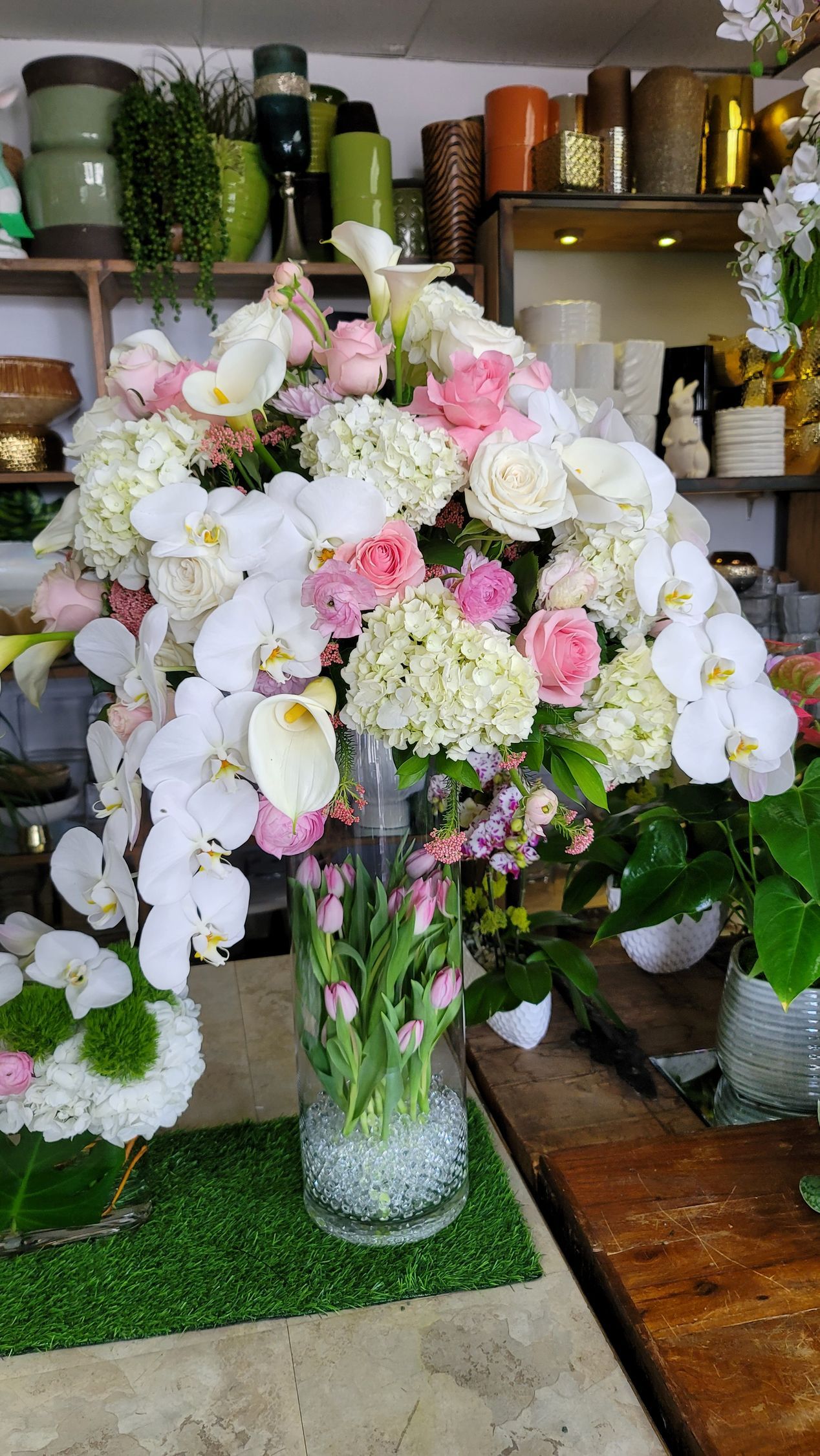 A vase filled with pink and white flowers is sitting on a table.