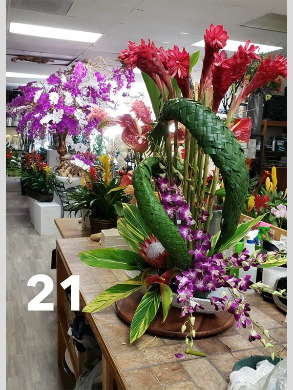 A bunch of flowers are sitting on a table in a flower shop.
