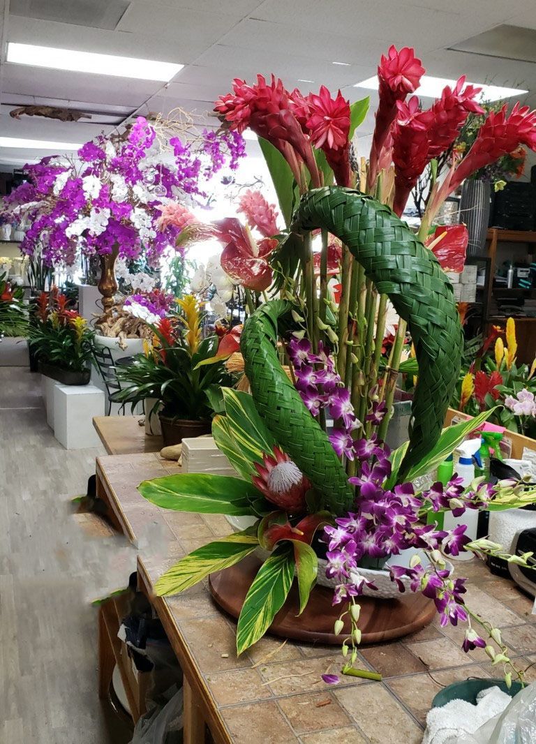 A bunch of flowers are sitting on a table in a flower shop.