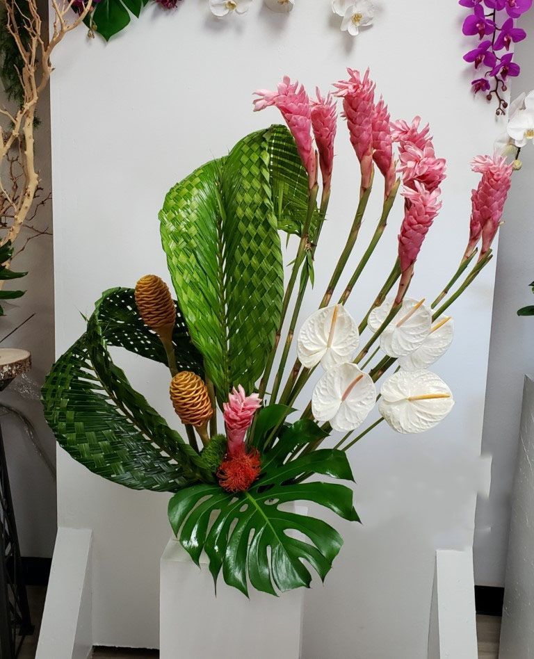 A bouquet of pink and white flowers and green leaves