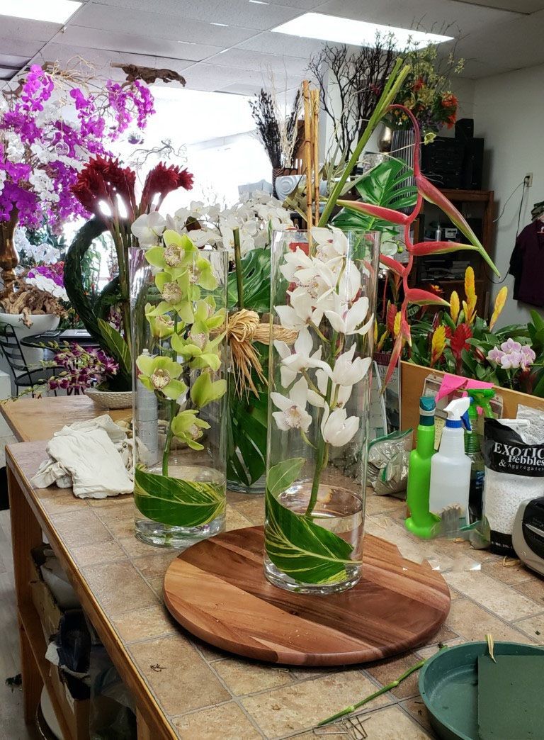 A vase filled with flowers is sitting on a wooden table.