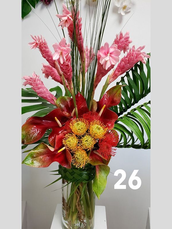 A vase of flowers with the number 26 on it