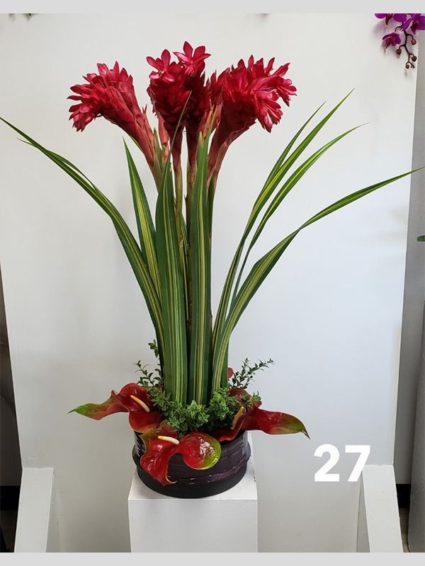 A vase of flowers with the number 27 on the bottom