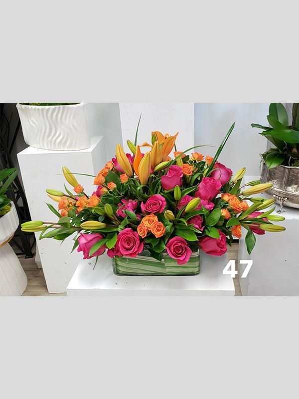 A vase filled with colorful flowers is sitting on a table.