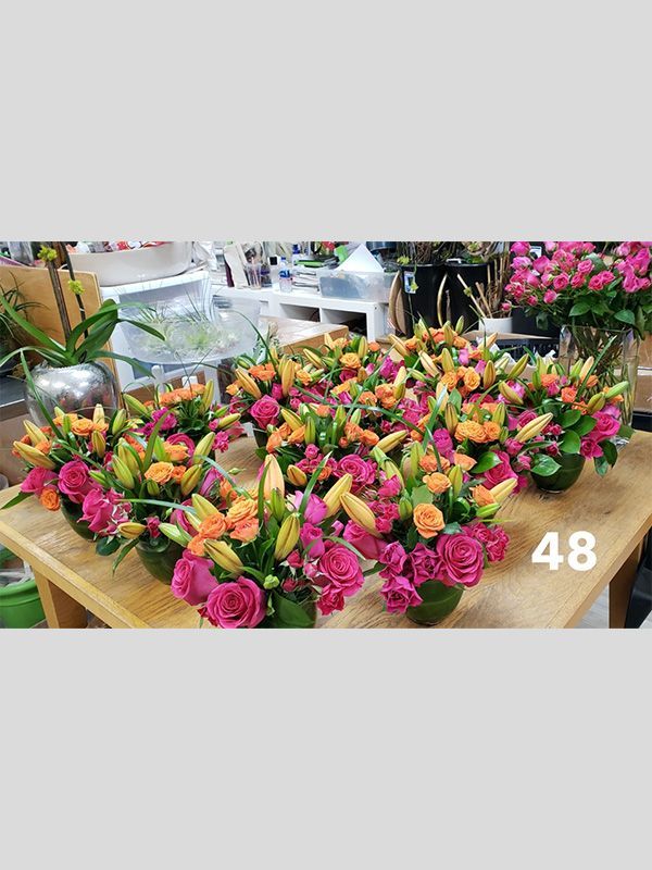 There are many different types of flowers on the table.