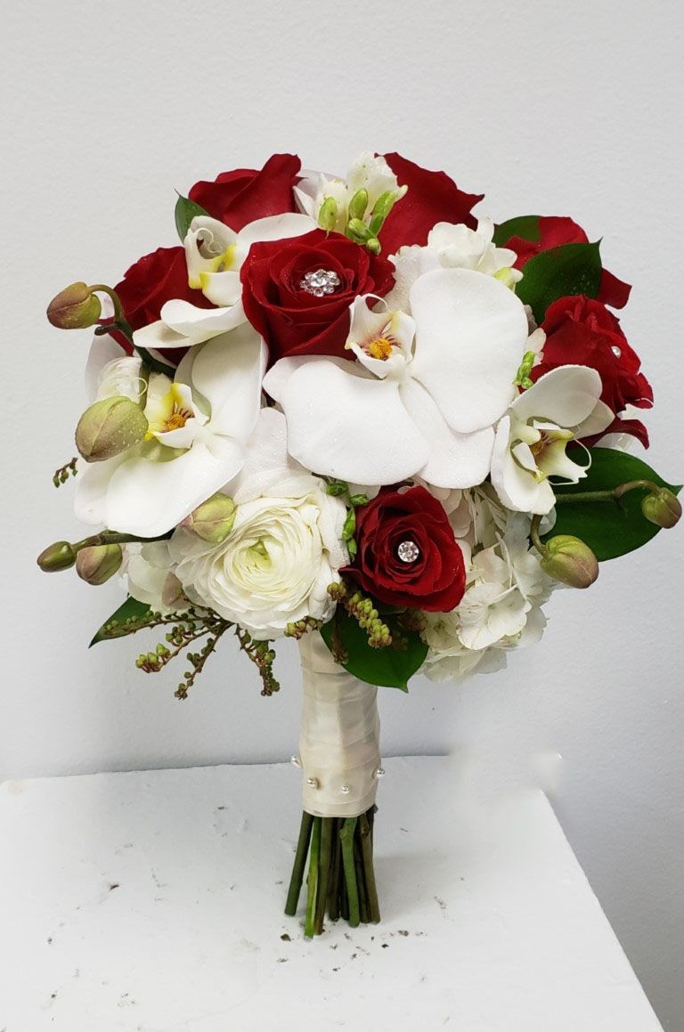 A bouquet of red and white flowers on a table