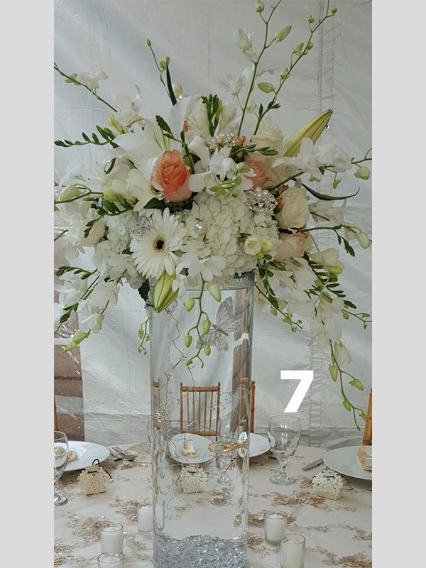 A table with a vase of flowers and the number 7 on it