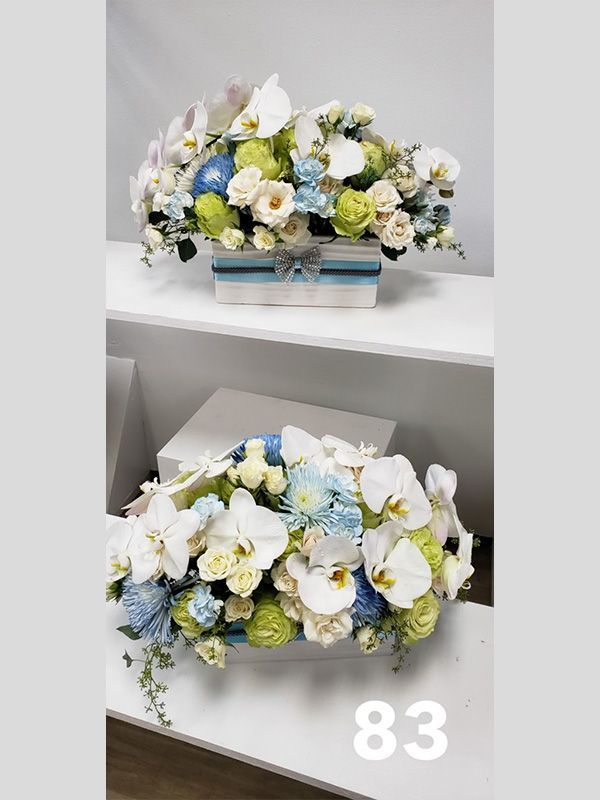 Two vases filled with flowers are sitting on a table.