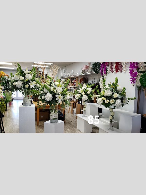 A florist shop filled with lots of white flowers.