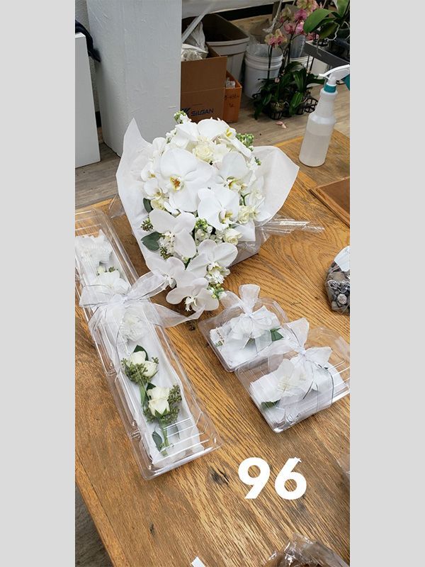 A bunch of white flowers are sitting on top of a wooden table.