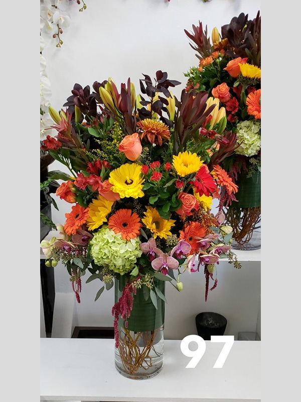 A vase of flowers with the number 97 on it