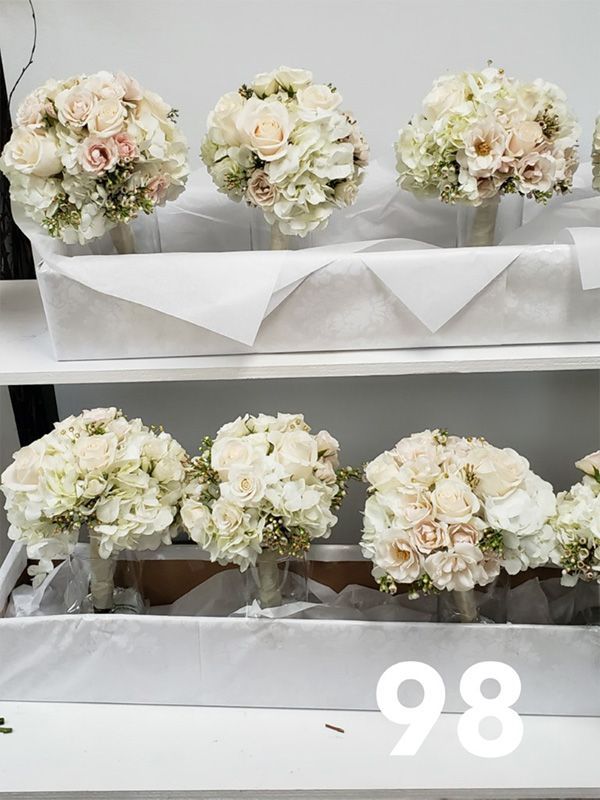 A bunch of white flowers are sitting on a shelf.