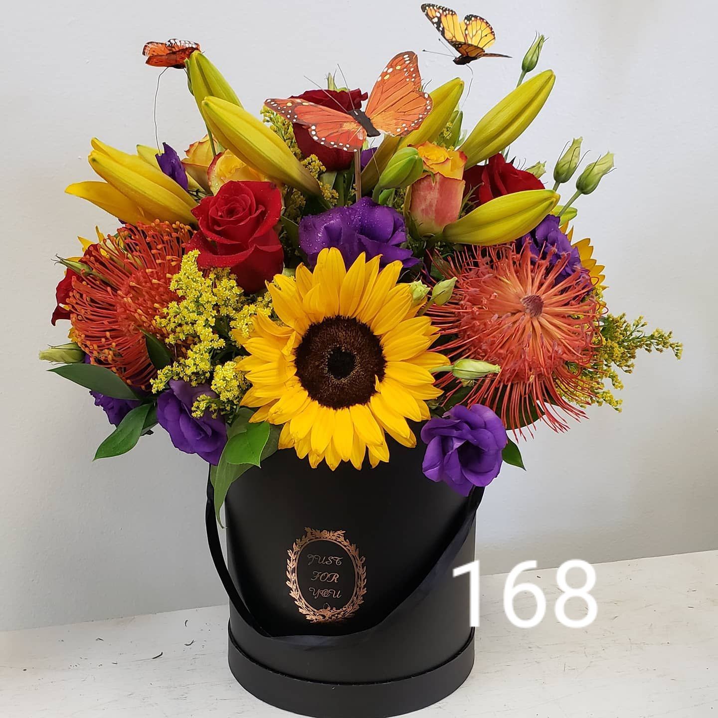 A bouquet of flowers in a black box with the number 168 on the bottom