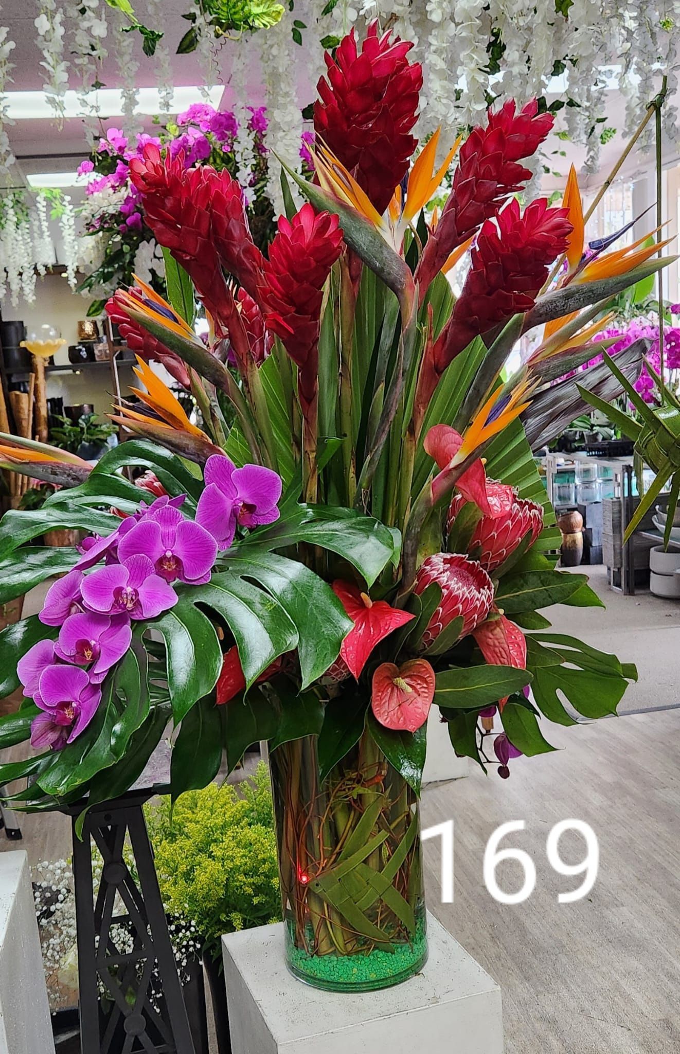 A vase filled with flowers is sitting on a table in a store.
