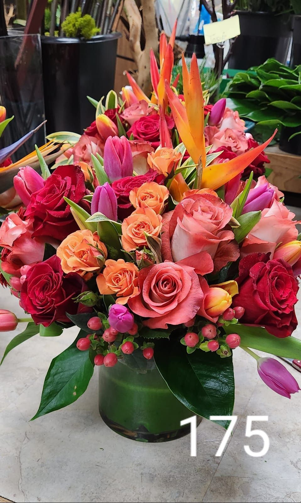 A vase filled with colorful flowers is sitting on a table.
