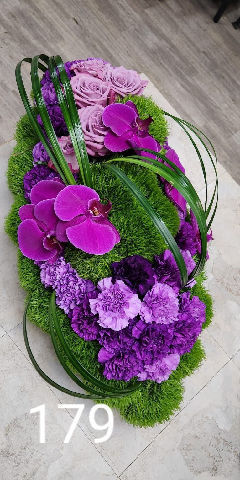 A bunch of purple flowers are sitting on top of a table.