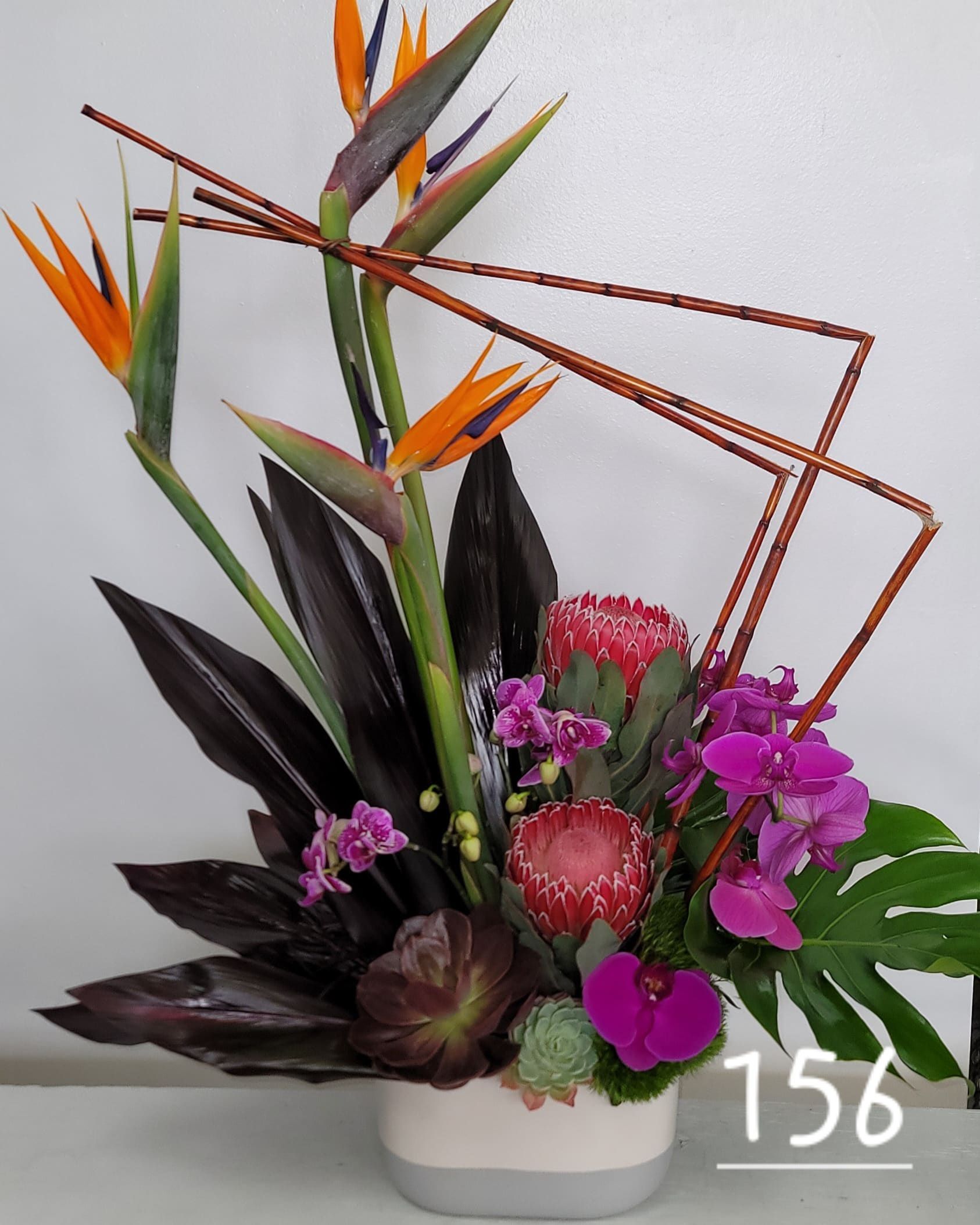 A vase of flowers with the number 156 on the bottom