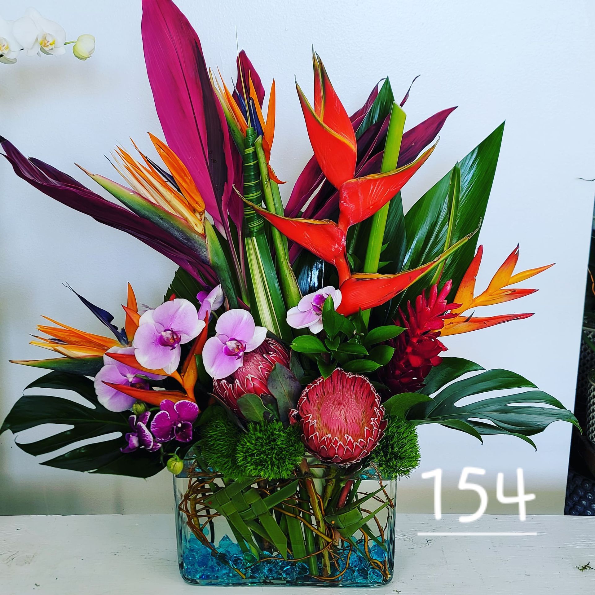 A vase of flowers with the number 154 on the bottom