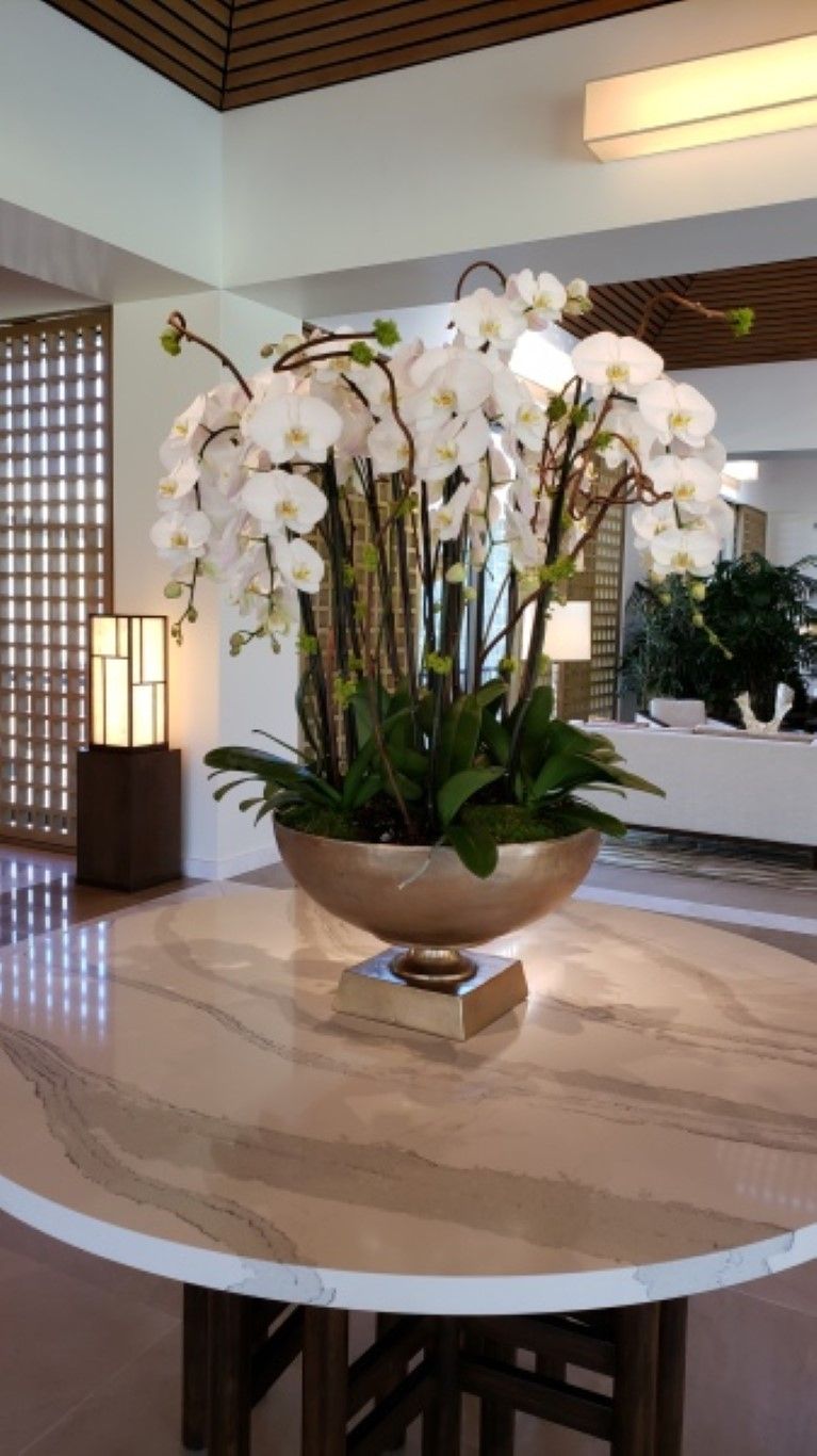 A table with a vase of flowers on it