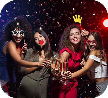 A group of women are holding champagne glasses at a party.