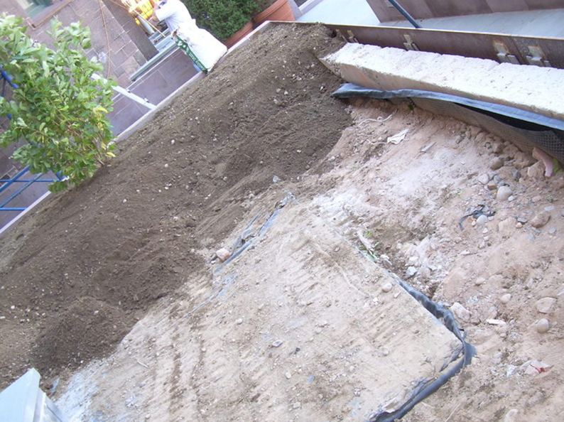 Dirt and soil being prepared for planting on a balcony.