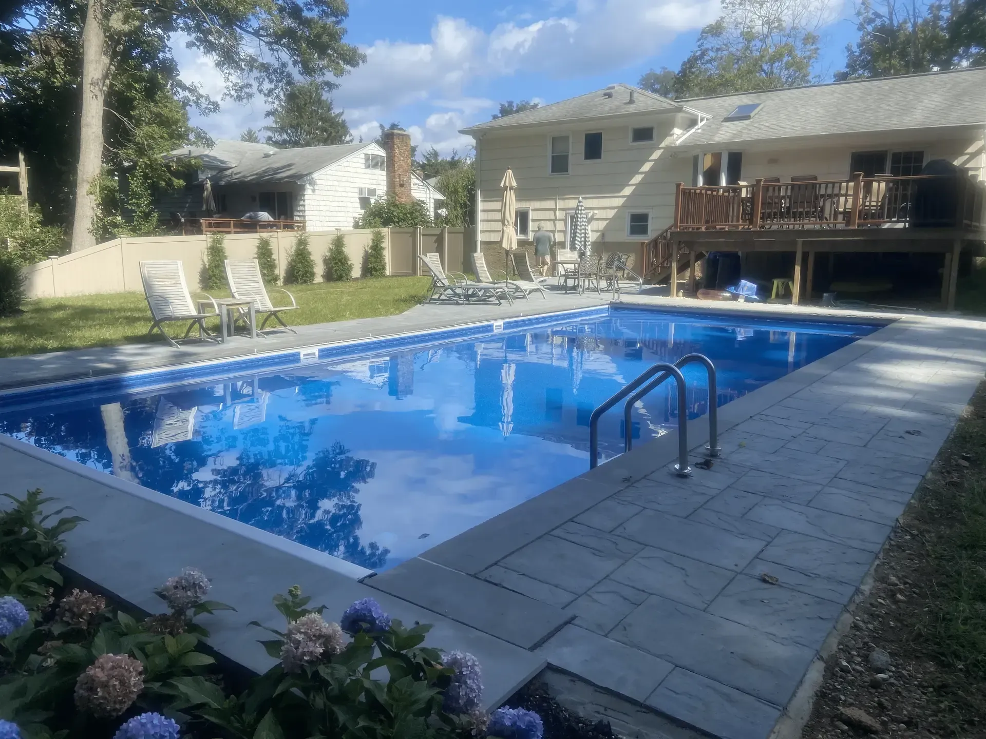 A large swimming pool in the backyard of a house