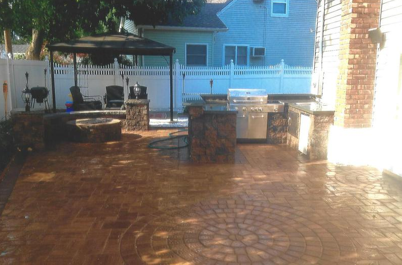 Outdoor patio with a grill, fire pit, and a gazebo.