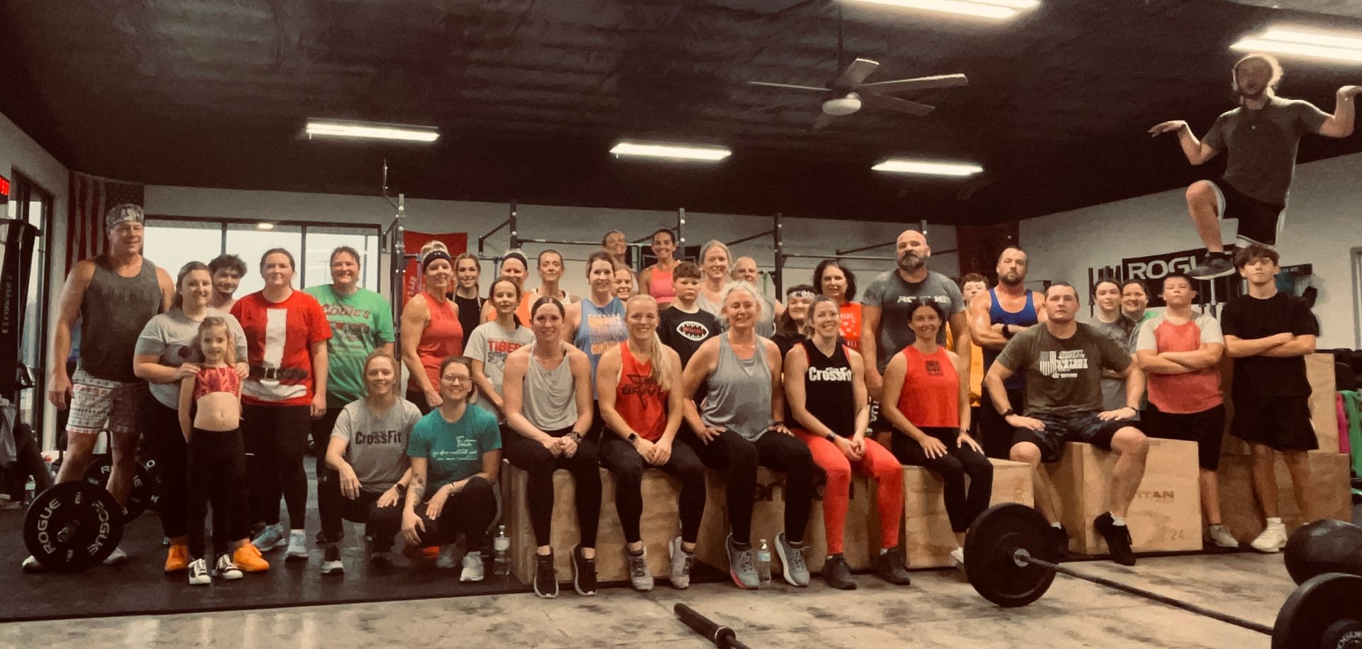 A group of people are posing for a picture in a gym.